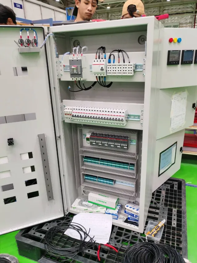 Open control cabinet with mounted meters and wiring