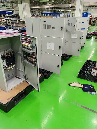 Open electrical cabinets arranged across a workshop floor