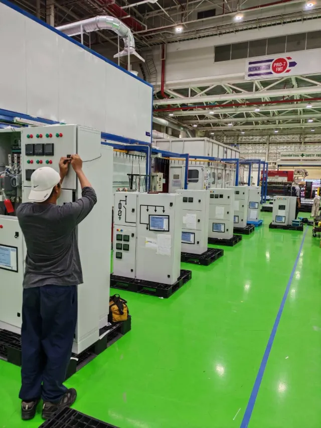 Electrical cabinet assemblies across a workshop