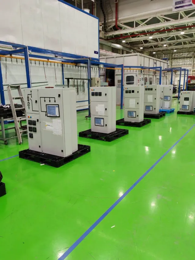 Rows of electrical cabinet assemblies on a workshop floor